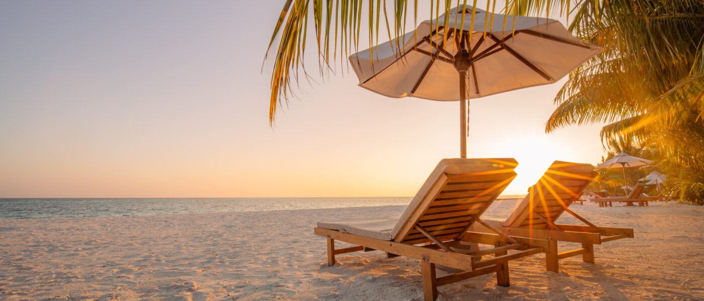 Sri Lanka east coast beach with palm trees and loungers